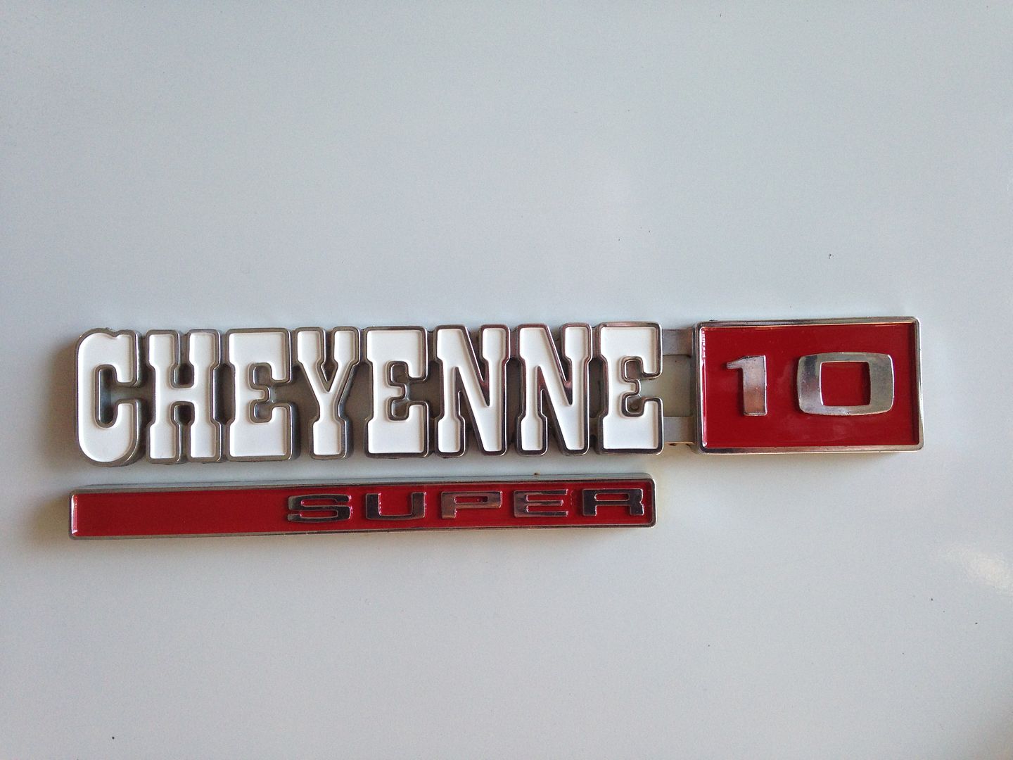 Painting emblems using lacquer paint and a hypodermic syringe The